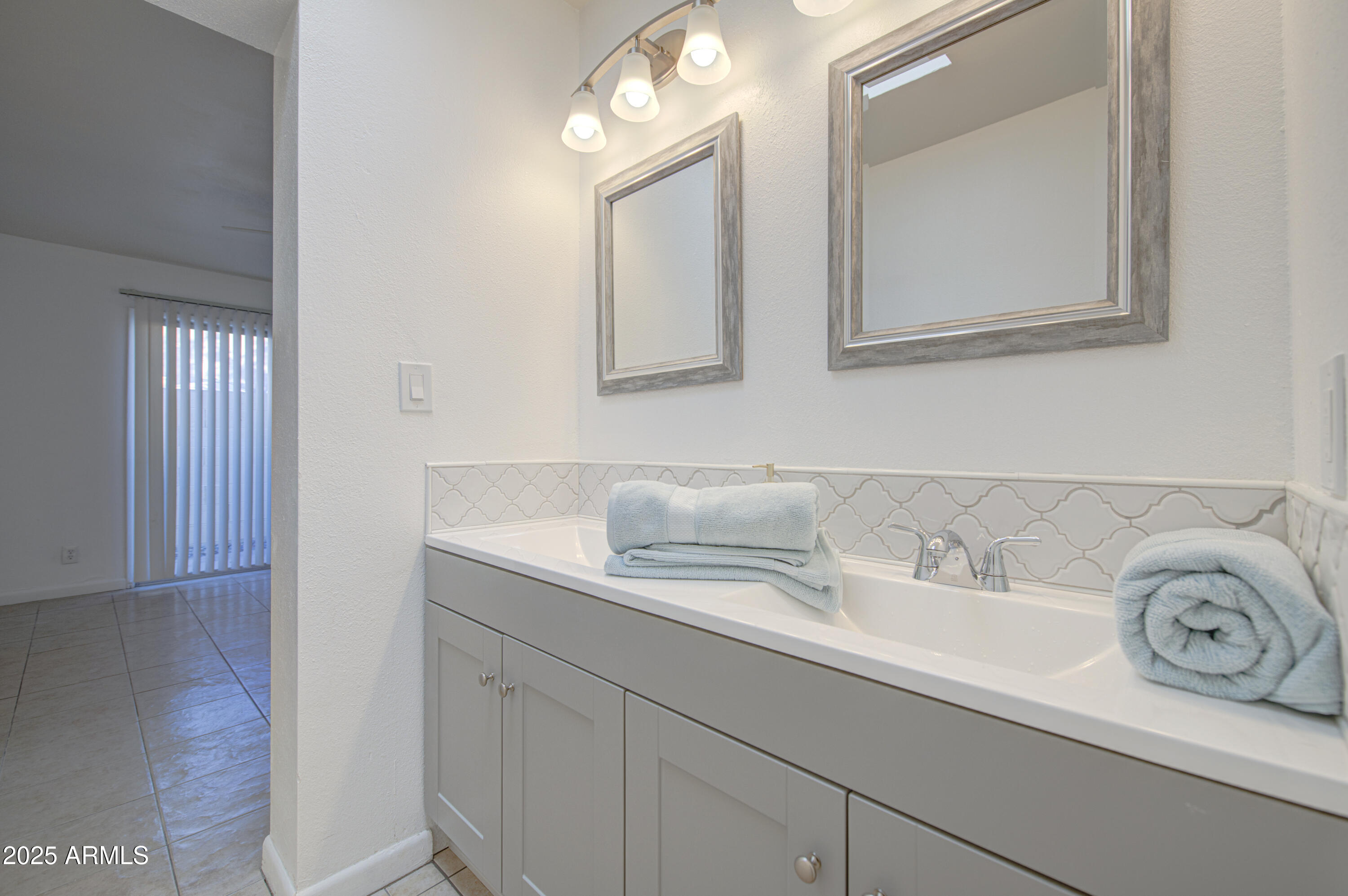712 South Lebanon Lane Tempe, AZ 85288 - Photo 32 of 35 a bathroom with a sink and a mirror
