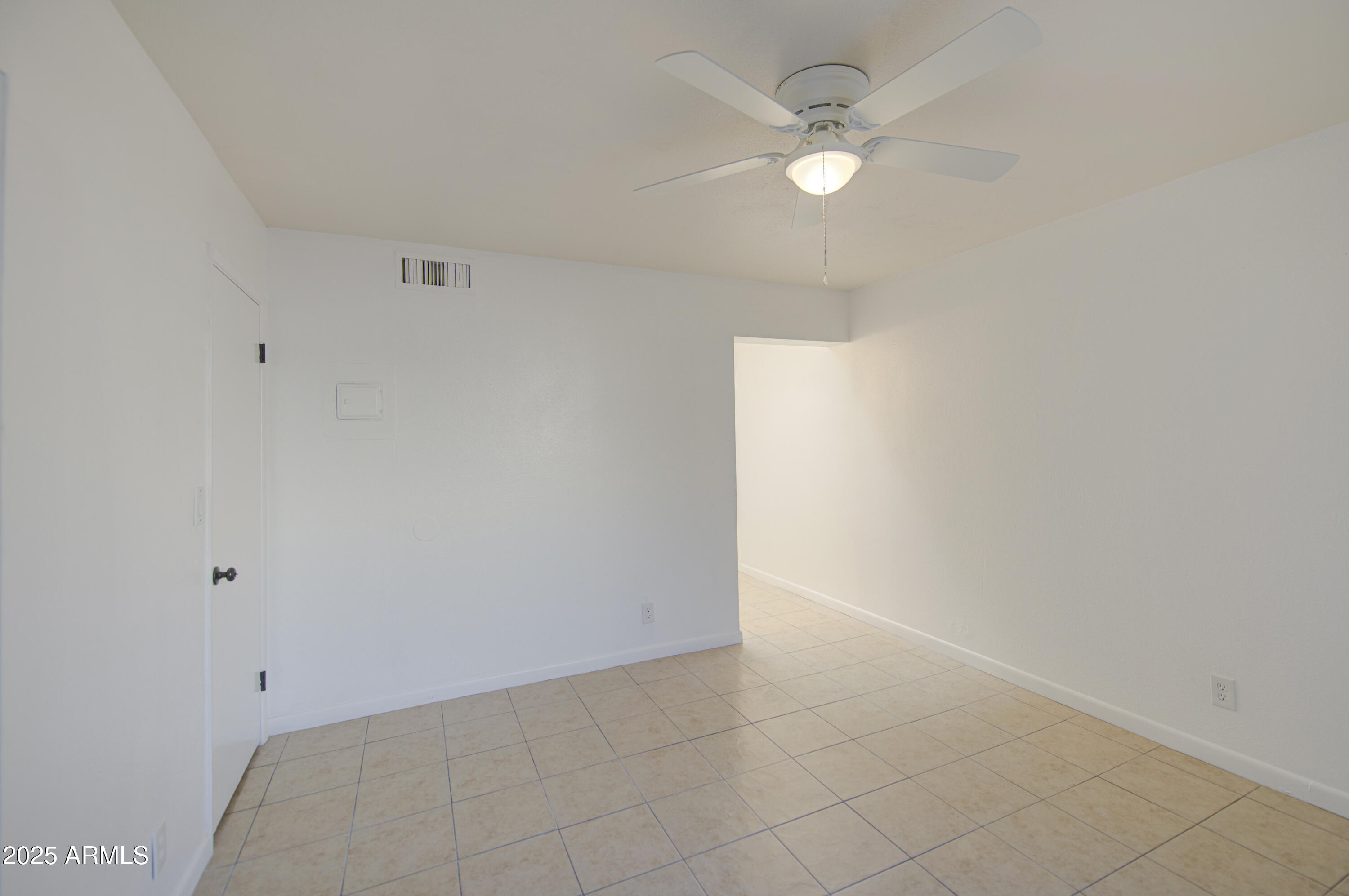 712 South Lebanon Lane Tempe, AZ 85288 - Photo 33 of 35 an empty room with a ceiling fan and carpet