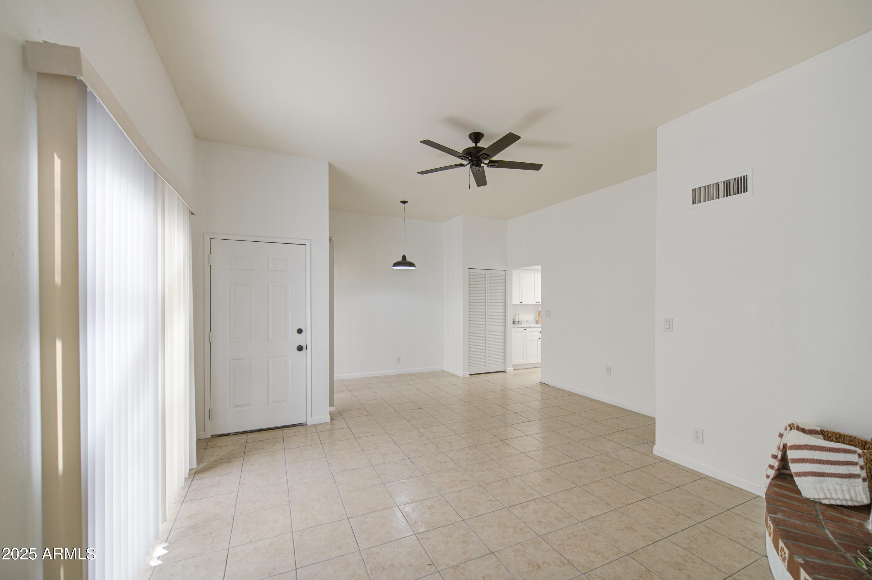 712 South Lebanon Lane Tempe, AZ 85288 - Photo 5 of 35 a view of an empty room with a ceiling fan