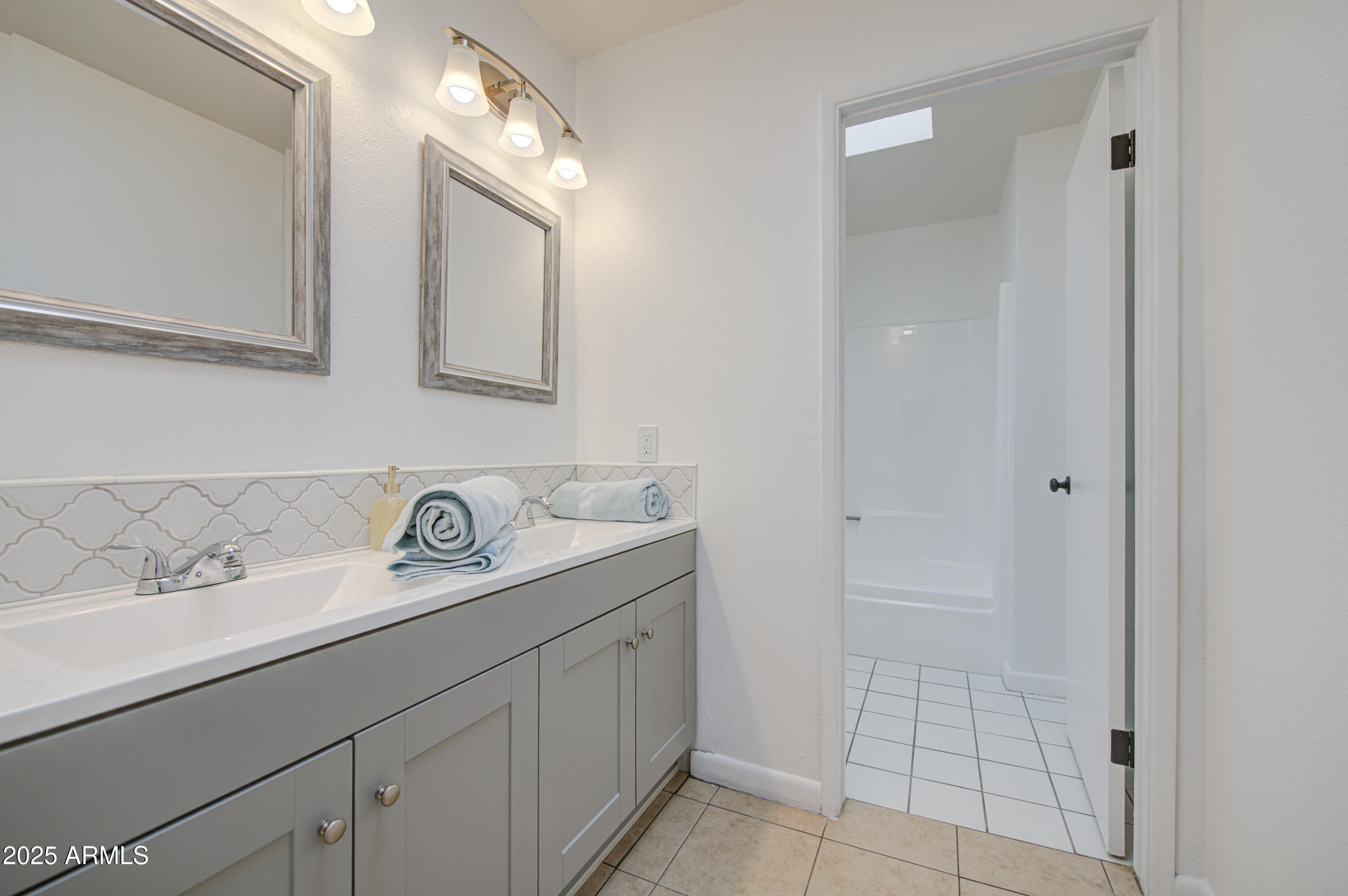 712 South Lebanon Lane Tempe, AZ 85288 - Photo 7 of 35 a bathroom with a granite countertop sink and a mirror