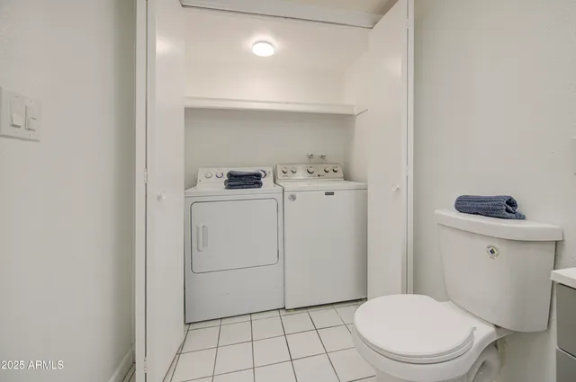 a white toilet sitting next to a bathroom sink