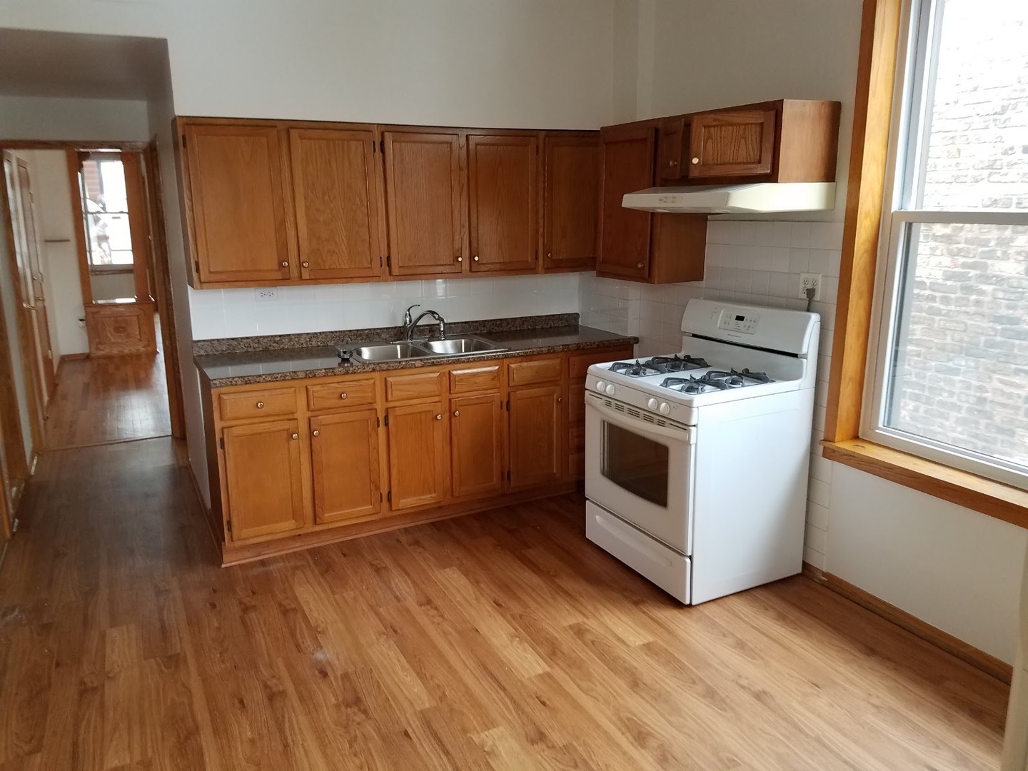 3513 North Pulaski Road Chicago, IL 60641 - Photo 25 of 33 a kitchen with stainless steel appliances granite countertop a stove a sink and a microwave