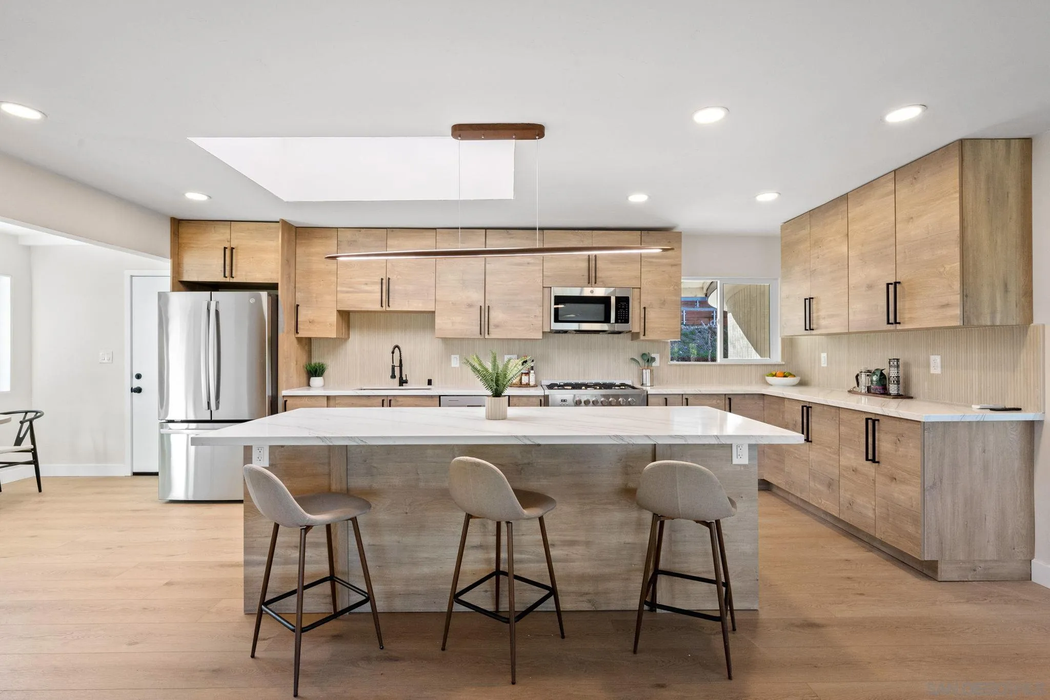 a kitchen with appliances a sink and cabinets
