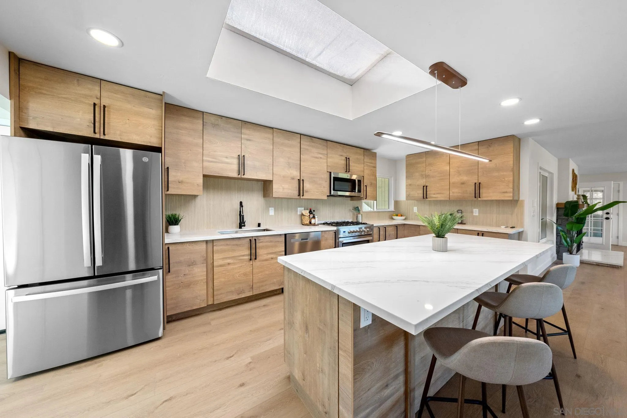 10104 Cristobal Drive Spring Valley, CA 91977 - Photo 17 of 56 a kitchen with stainless steel appliances a refrigerator a stove a sink a dining table and chairs