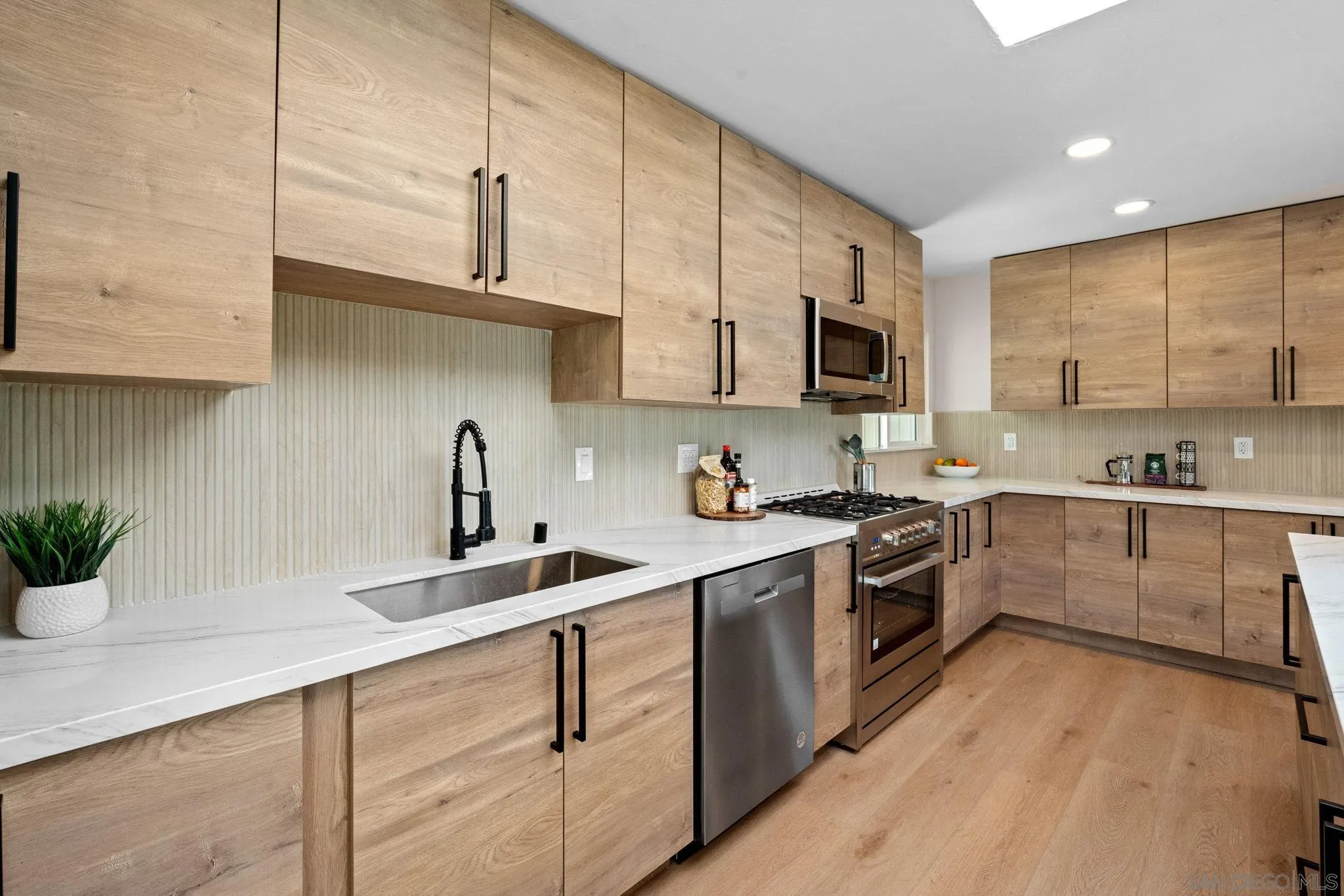 10104 Cristobal Drive Spring Valley, CA 91977 - Photo 18 of 56 a kitchen with kitchen island granite countertop a sink a stove and cabinets