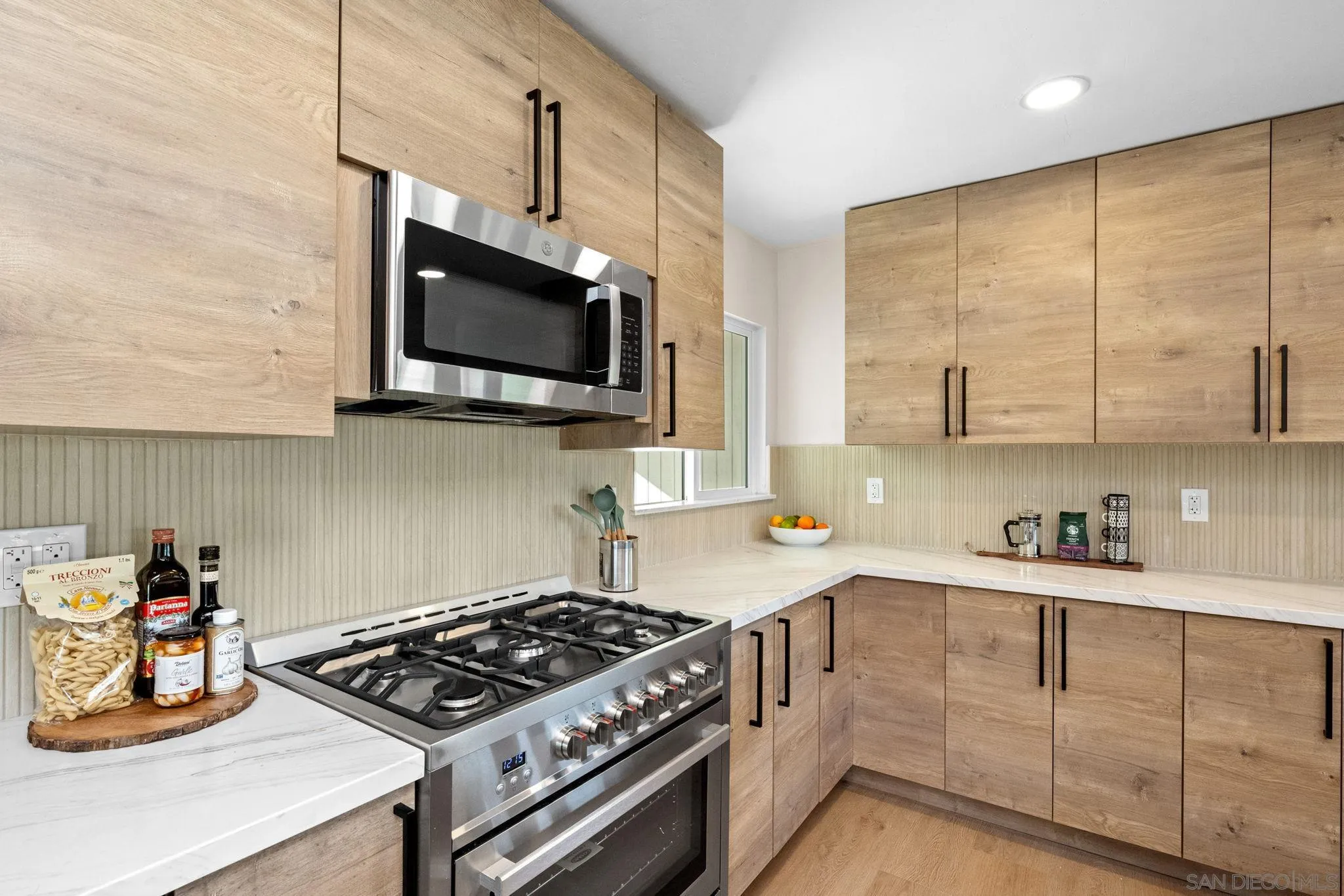 10104 Cristobal Drive Spring Valley, CA 91977 - Photo 21 of 56 a kitchen with stainless steel appliances granite countertop a stove a sink and a microwave
