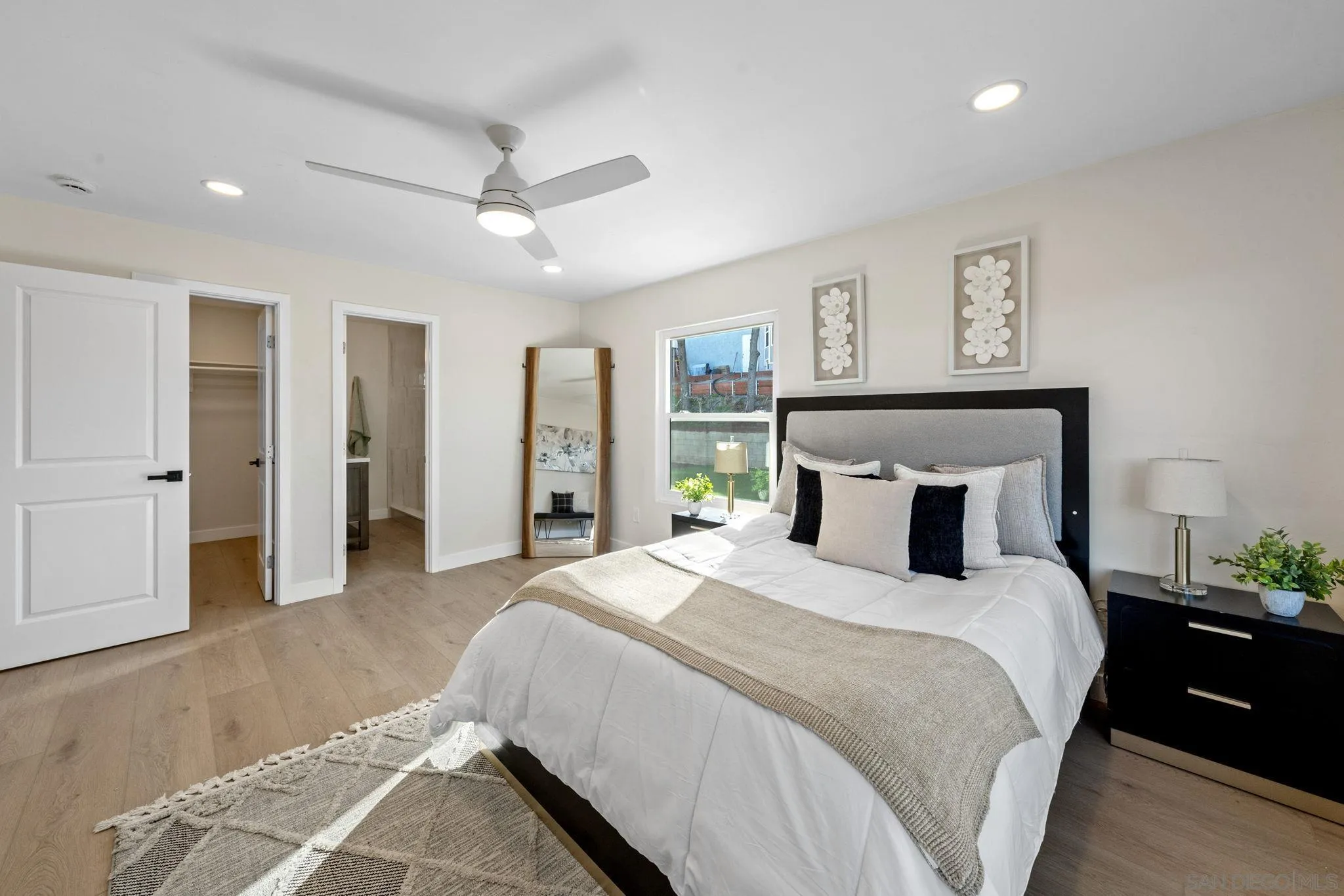 10104 Cristobal Drive Spring Valley, CA 91977 - Photo 26 of 56 a bedroom with a large bed and a chandelier