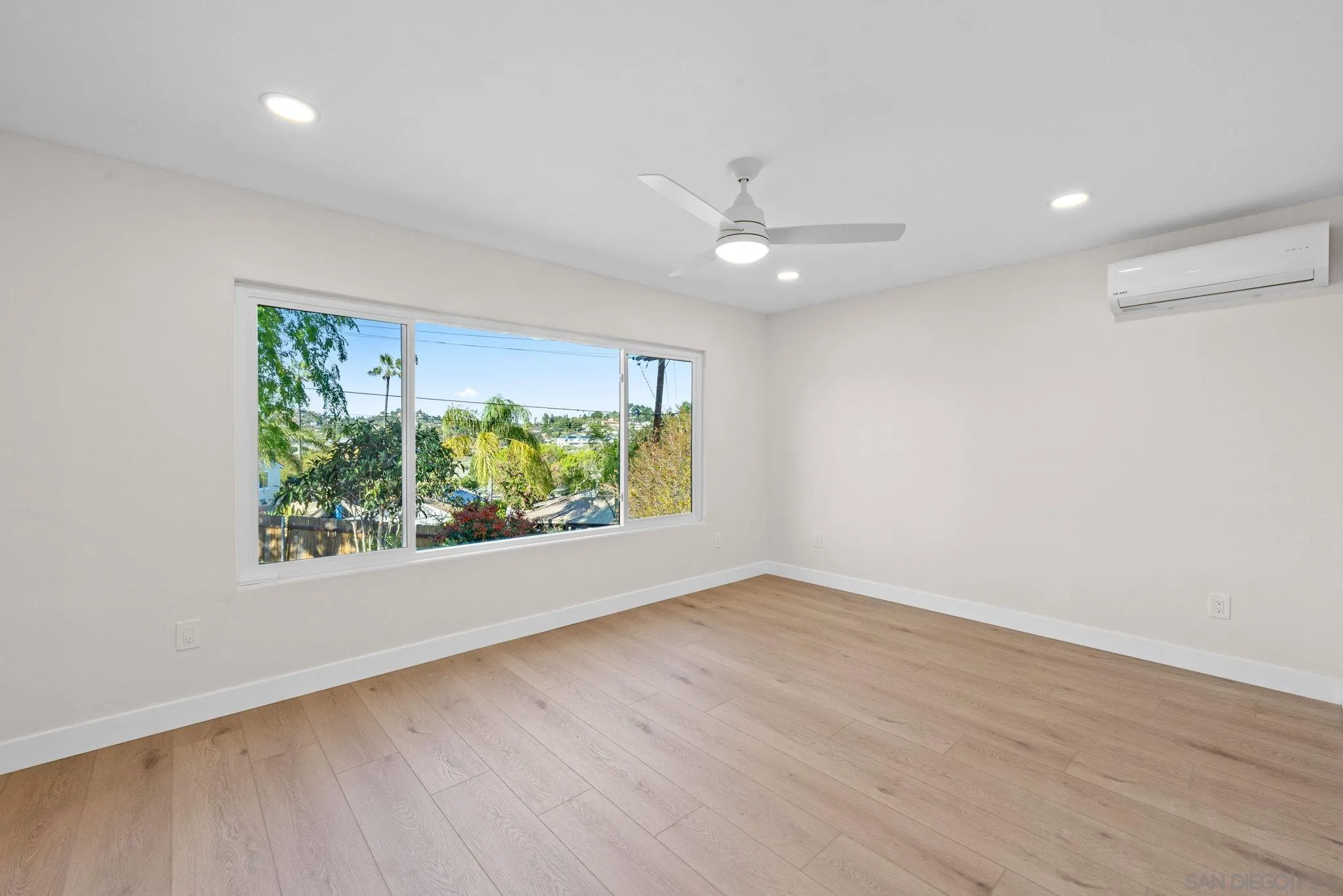10104 Cristobal Drive Spring Valley, CA 91977 - Photo 29 of 56 an empty room with wooden floor fan and windows