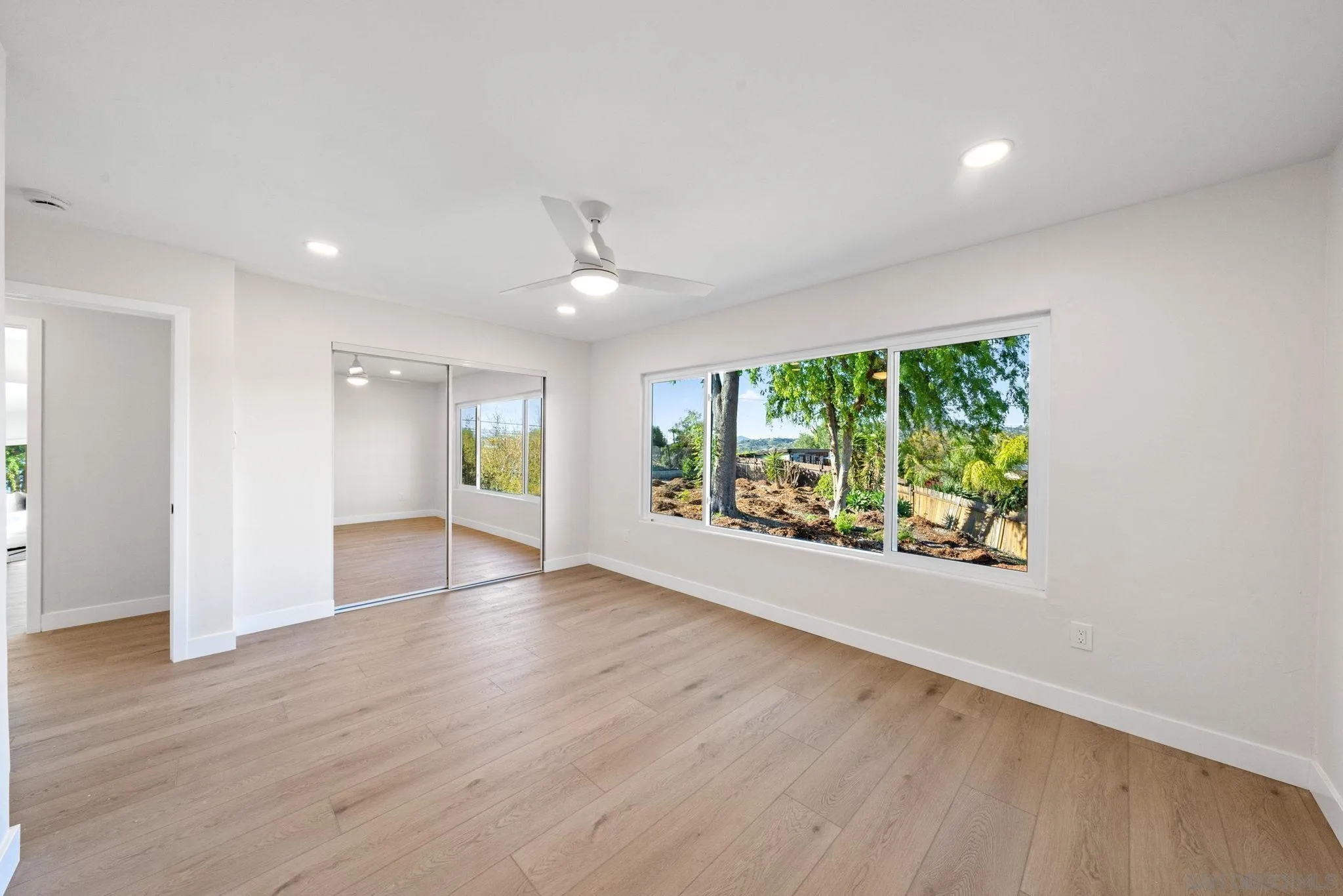 10104 Cristobal Drive Spring Valley, CA 91977 - Photo 30 of 56 an empty room with wooden floor and windows