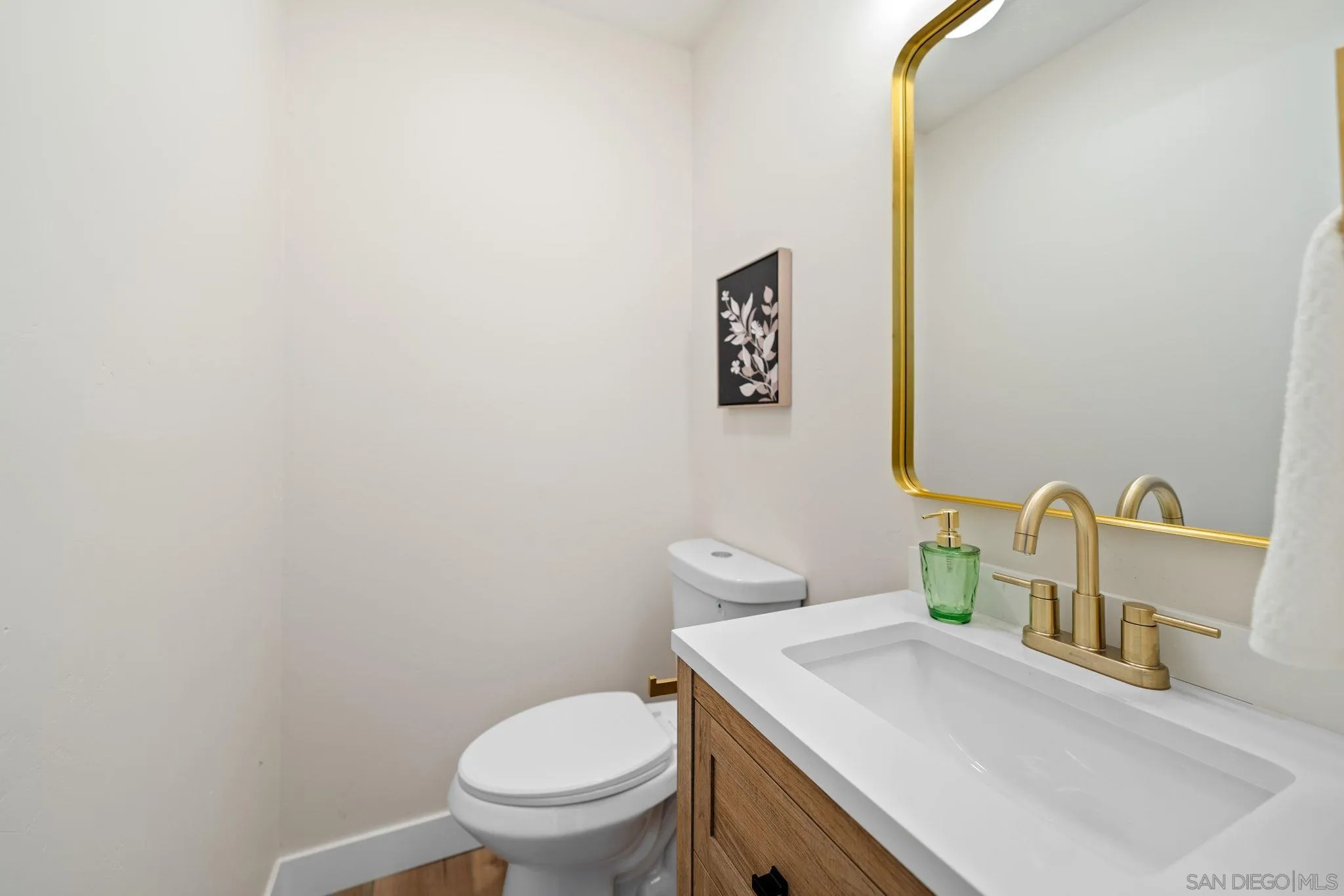 10104 Cristobal Drive Spring Valley, CA 91977 - Photo 33 of 56 a bathroom with a sink a toilet and mirror