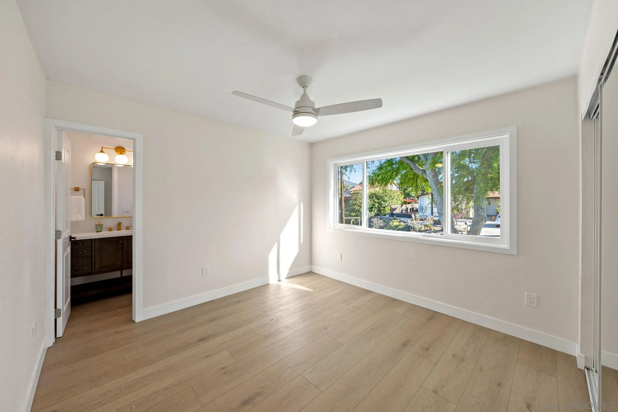 10104 Cristobal Drive Spring Valley, CA 91977 - Photo 35 of 56 an empty room with wooden floor cabinet and windows