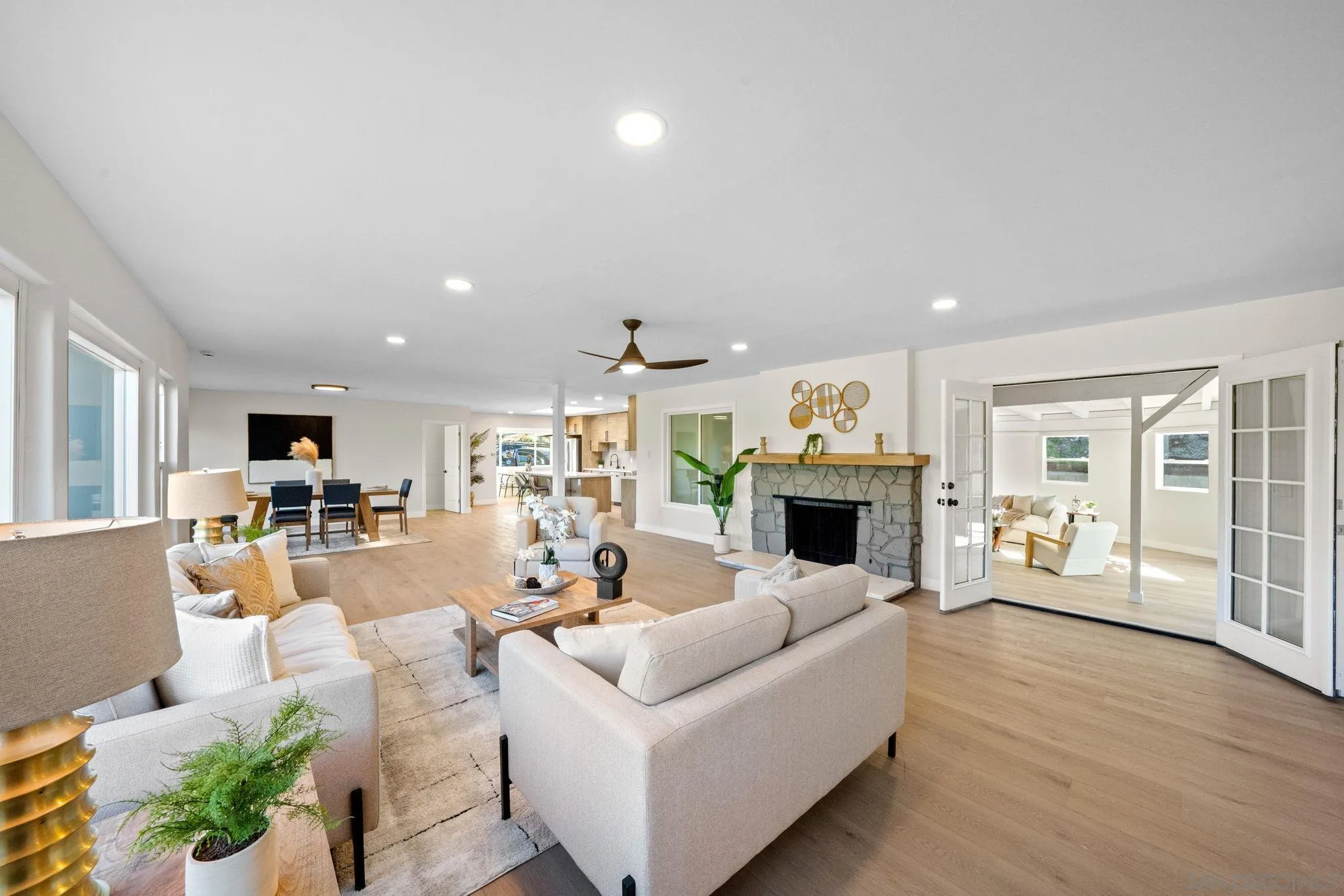 10104 Cristobal Drive Spring Valley, CA 91977 - Photo 7 of 56 a living room with furniture a fireplace and a dining table with wooden floor