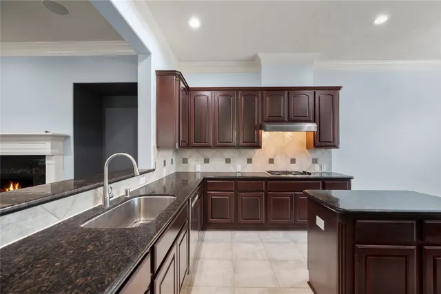 a kitchen with a sink stove and cabinets