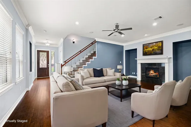 a living room with furniture and a fireplace