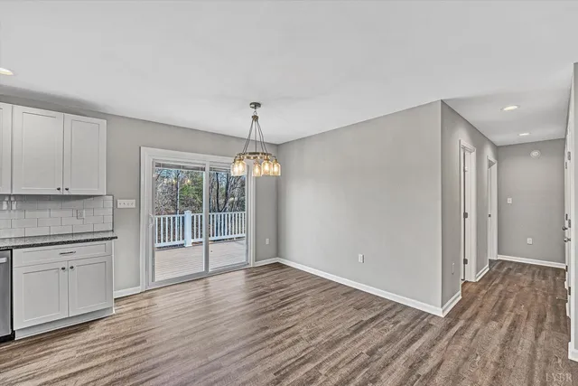 a open kitchen with stainless steel appliances granite countertop a refrigerator and a stove top oven