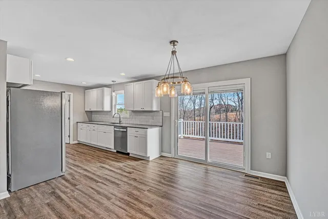 a view of a kitchen with wooden floor and a sink