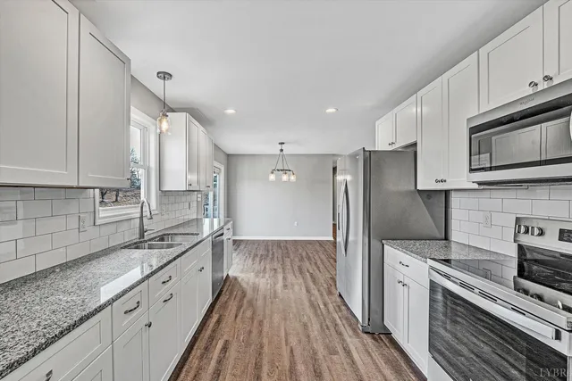 a view of a closet area with wooden floor