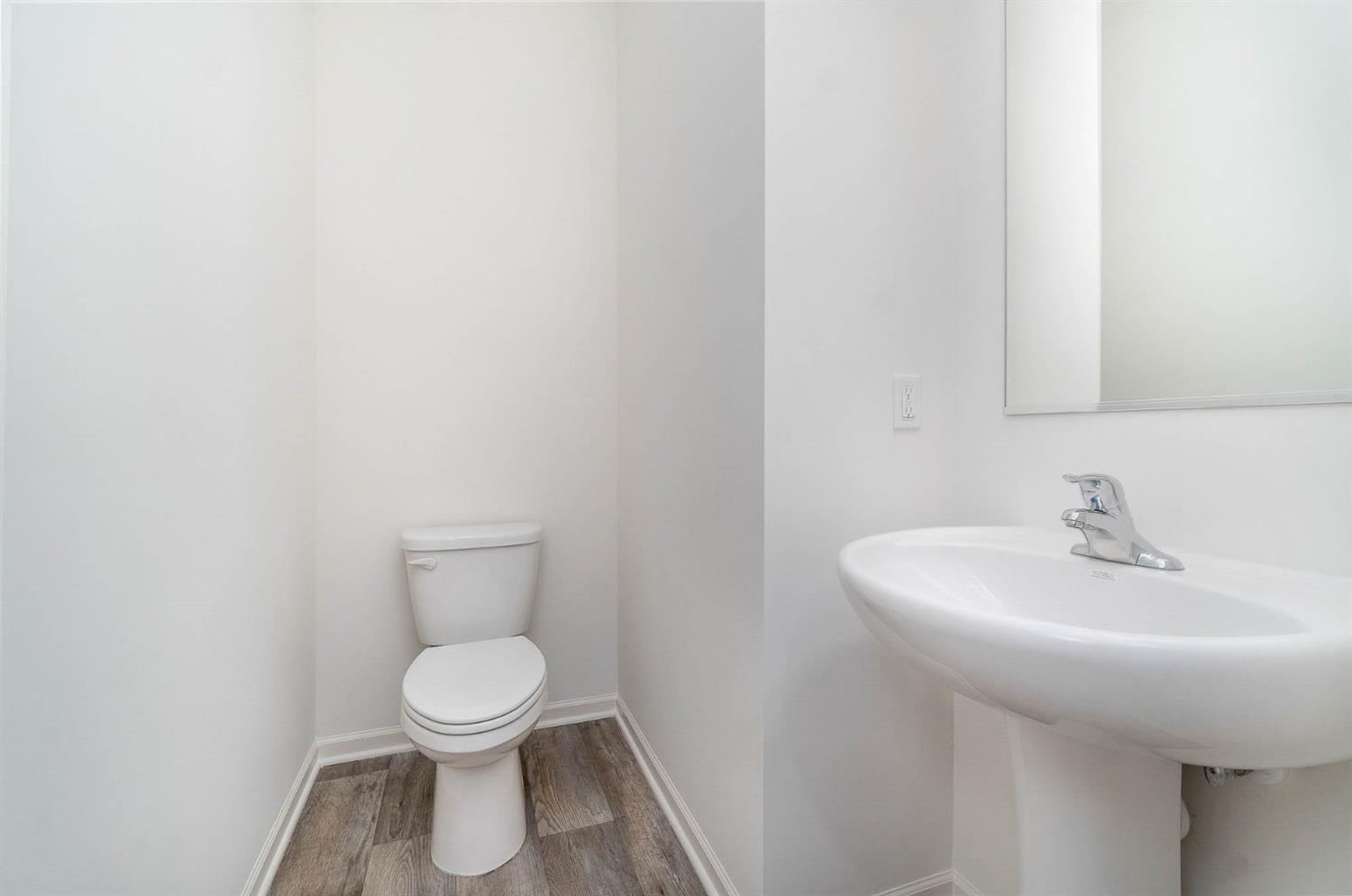 10354 Bryan Place Crown Point, IN 46307 - Photo 11 of 35 a bathroom with a sink a toilet and a mirror