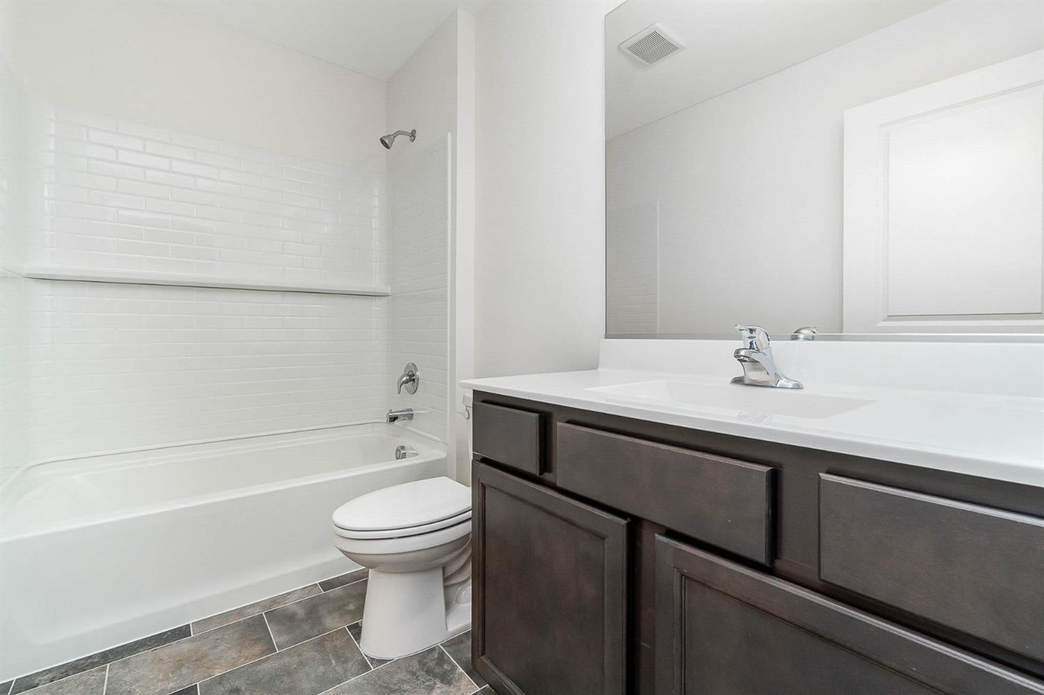 10354 Bryan Place Crown Point, IN 46307 - Photo 18 of 35 a bathroom with a sink a toilet and shower