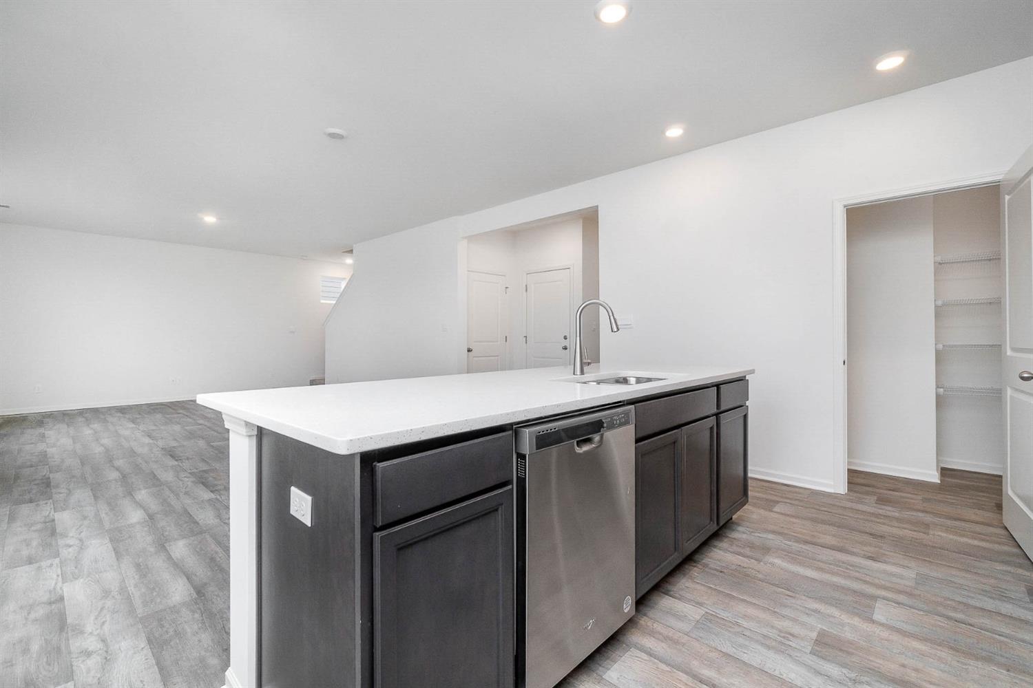 10354 Bryan Place Crown Point, IN 46307 - Photo 6 of 35 a kitchen with a sink and wooden floor
