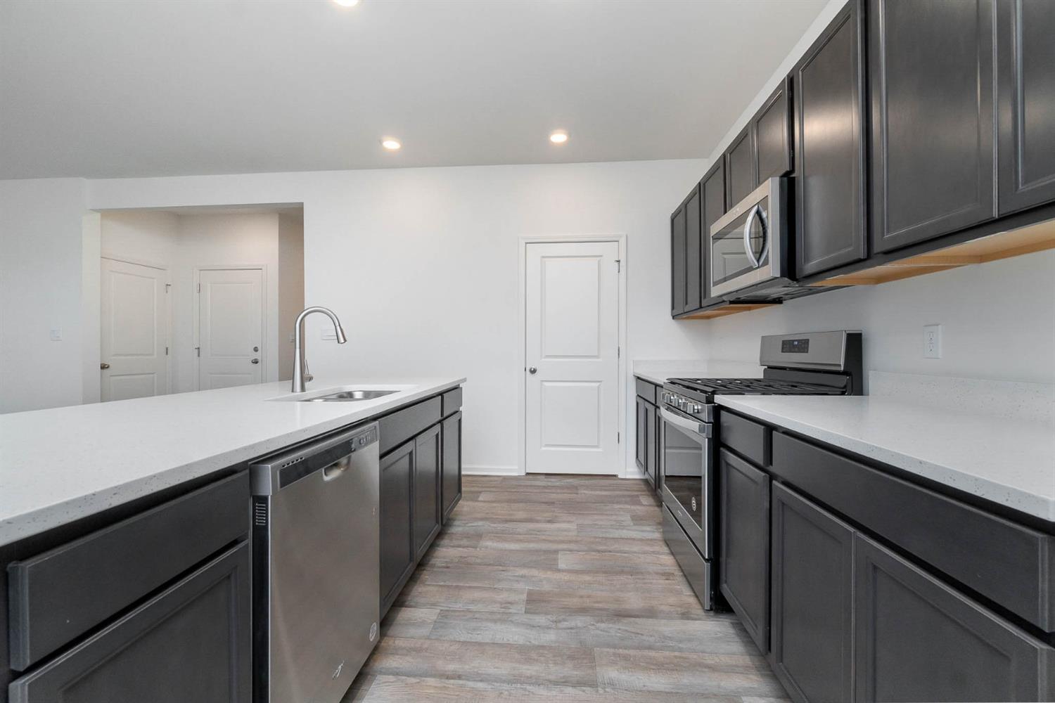 10354 Bryan Place Crown Point, IN 46307 - Photo 7 of 35 a kitchen with stainless steel appliances granite countertop a sink and stove