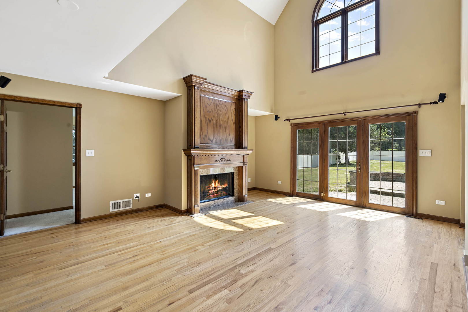 23501 West McClintock Road Channahon, IL 60410 - Photo 5 of 19 a view of an empty room with wooden floor and a fireplace