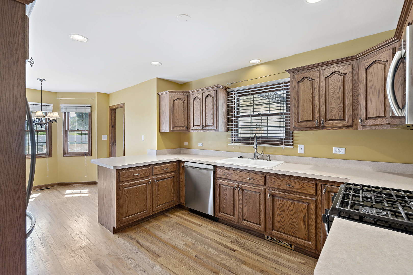 23501 West McClintock Road Channahon, IL 60410 - Photo 7 of 19 a large kitchen with stainless steel appliances granite countertop a sink and cabinets