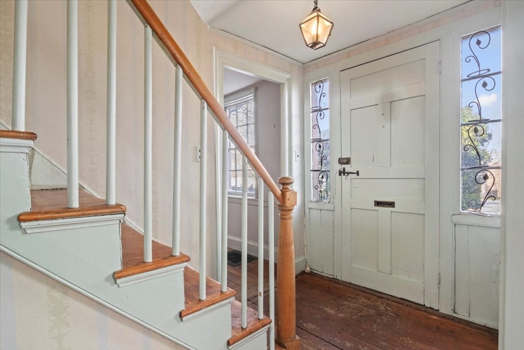 a view of staircase with wooden floor and a chandelier