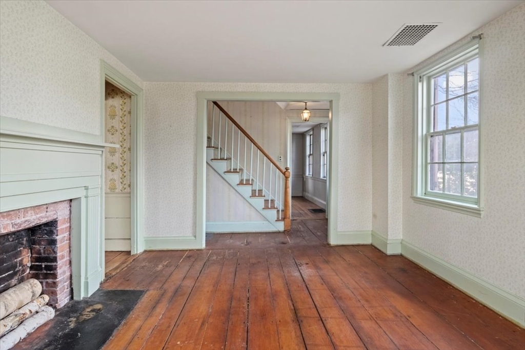 600 High Street Westwood, MA 02090 - Photo 5 of 27 a view of empty room with wooden floor and fireplace