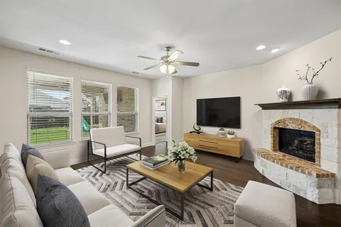 a kitchen with stainless steel appliances granite countertop a sink dishwasher and white cabinets with wooden floor