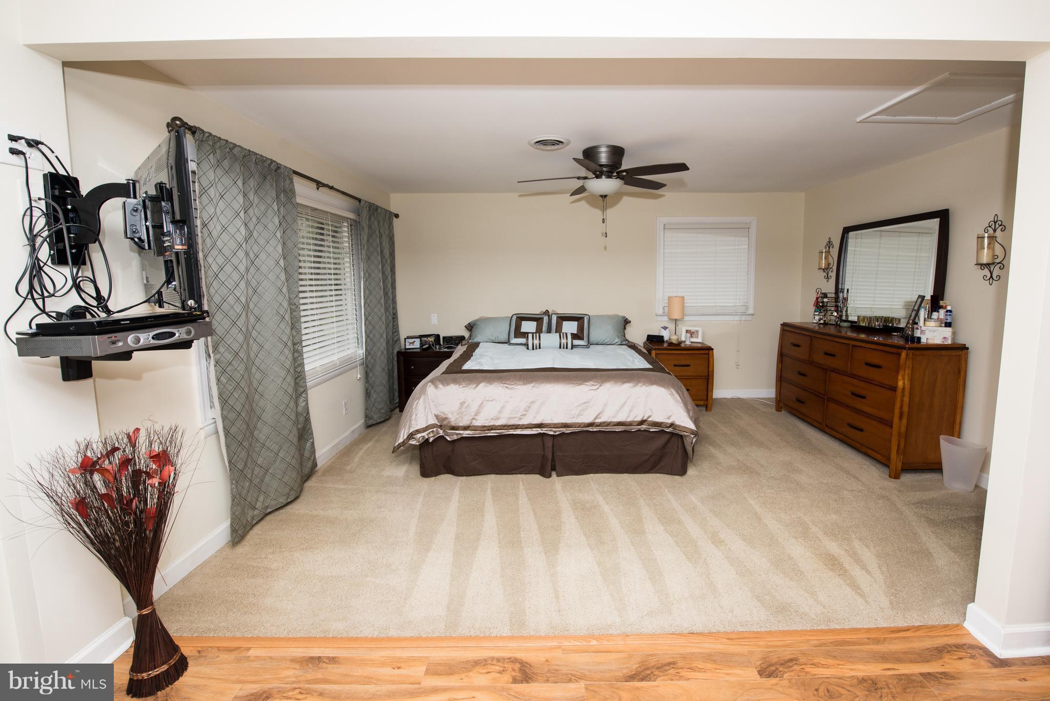 604 Bryan Point Road Accokeek, MD 20607 - Photo 11 of 29 a bedroom with a bed and a chandelier