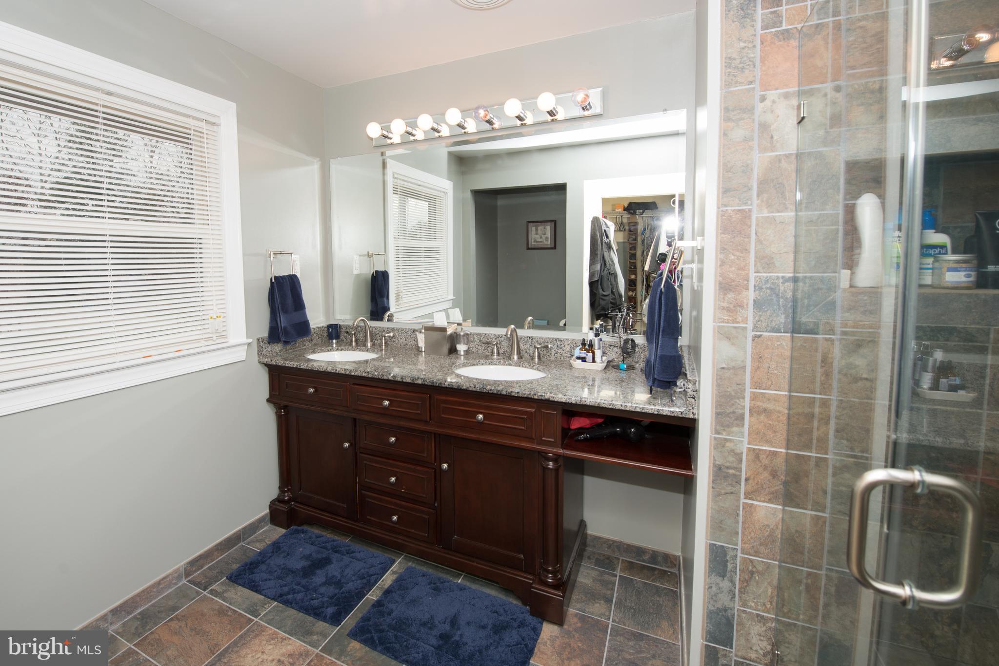 604 Bryan Point Road Accokeek, MD 20607 - Photo 14 of 29 a bathroom with a sink shower and a mirror