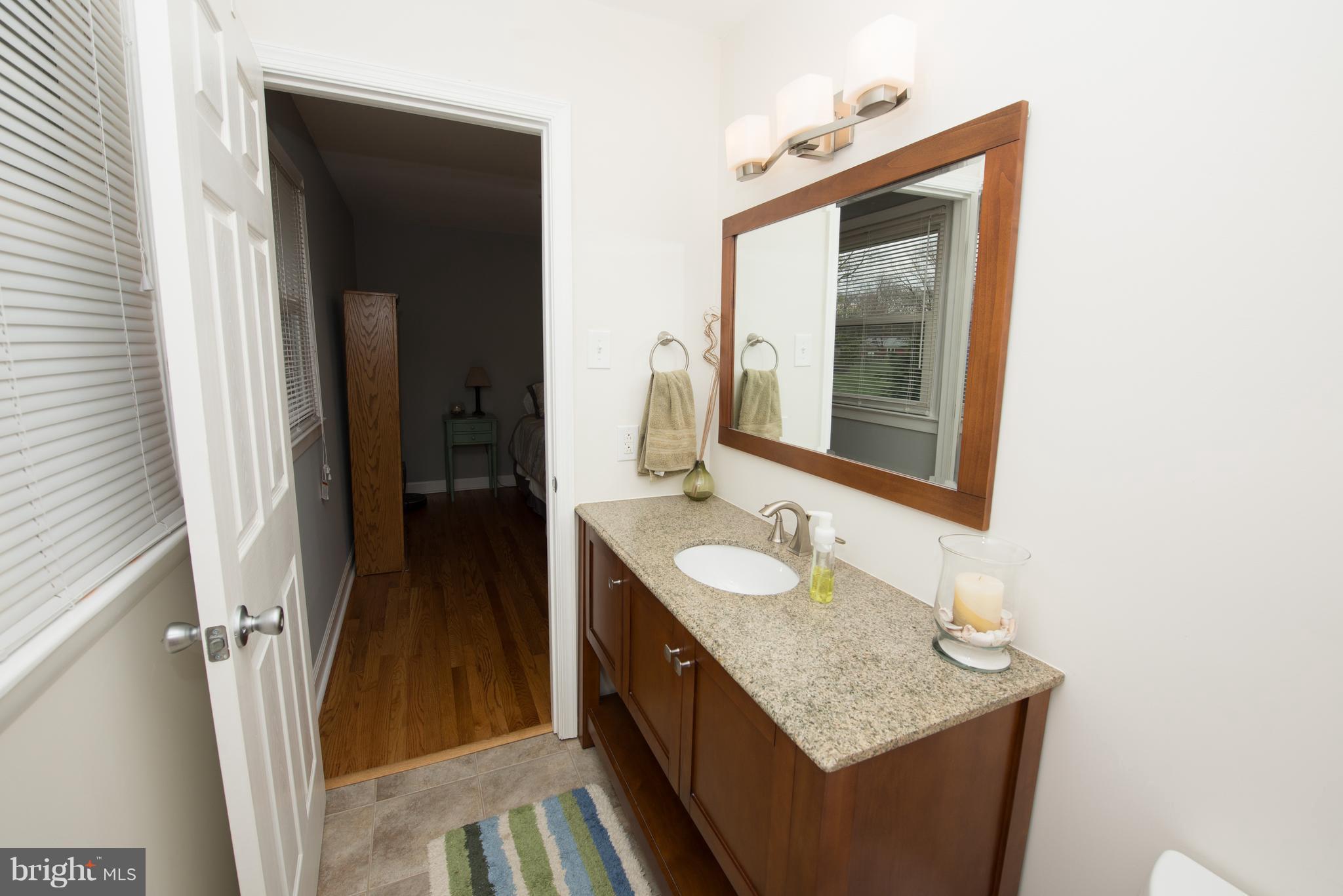 604 Bryan Point Road Accokeek, MD 20607 - Photo 16 of 29 a en suite bathroom with a granite countertop sink and a mirror