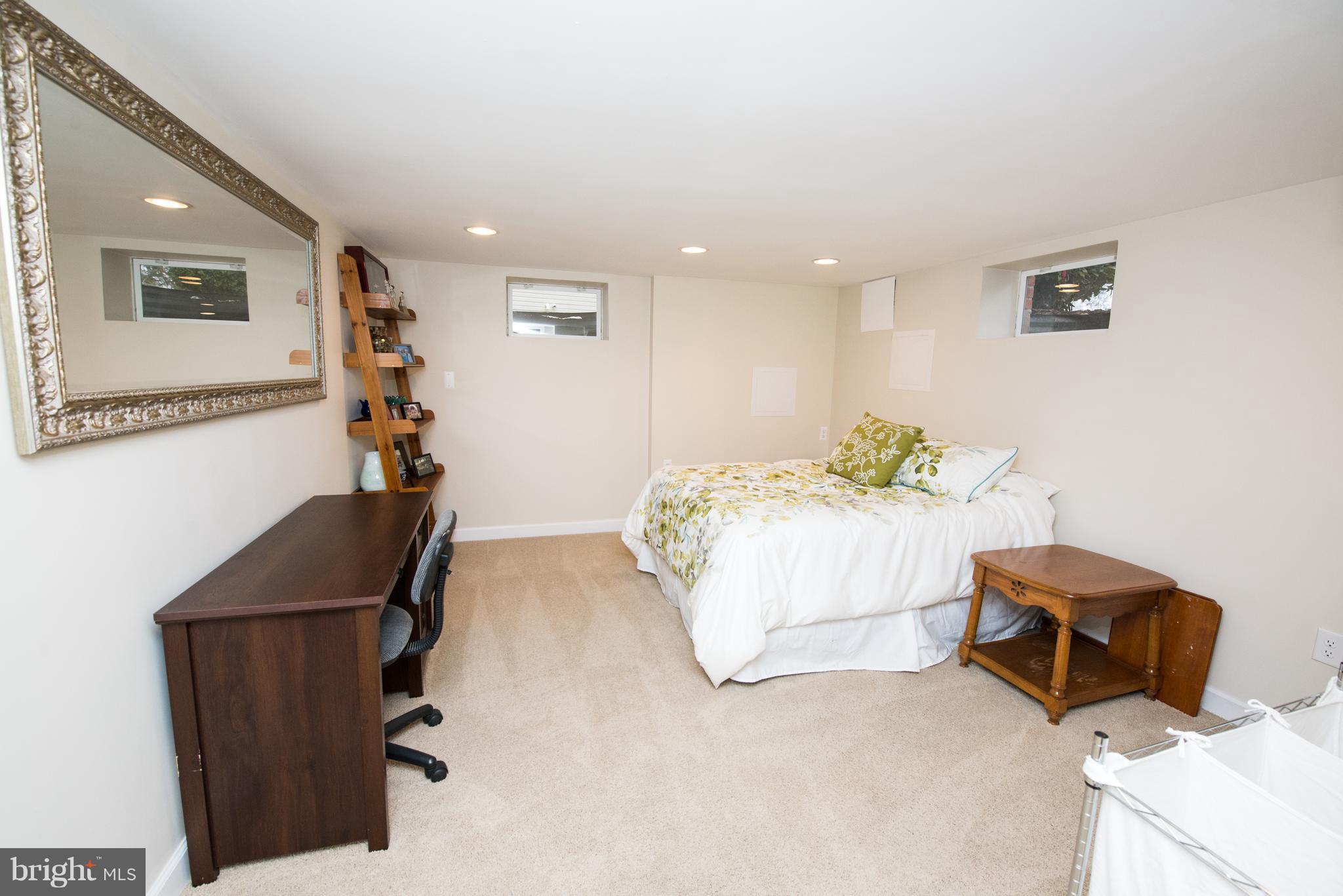 604 Bryan Point Road Accokeek, MD 20607 - Photo 22 of 29 a bedroom with furniture and a potted plant