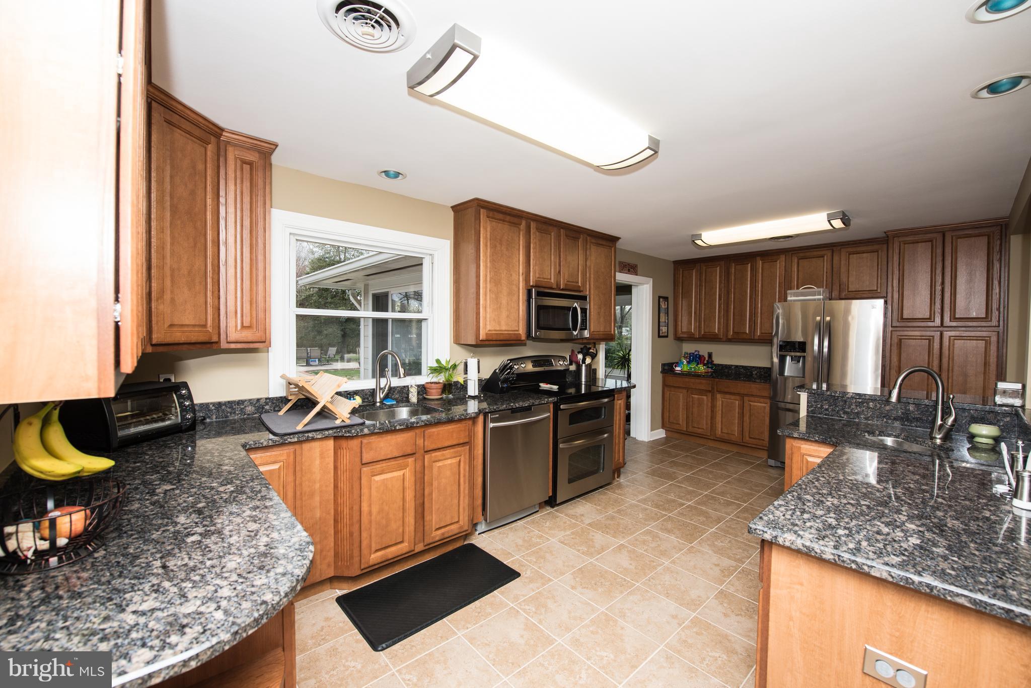604 Bryan Point Road Accokeek, MD 20607 - Photo 4 of 29 a kitchen with stainless steel appliances granite countertop a sink stove and refrigerator
