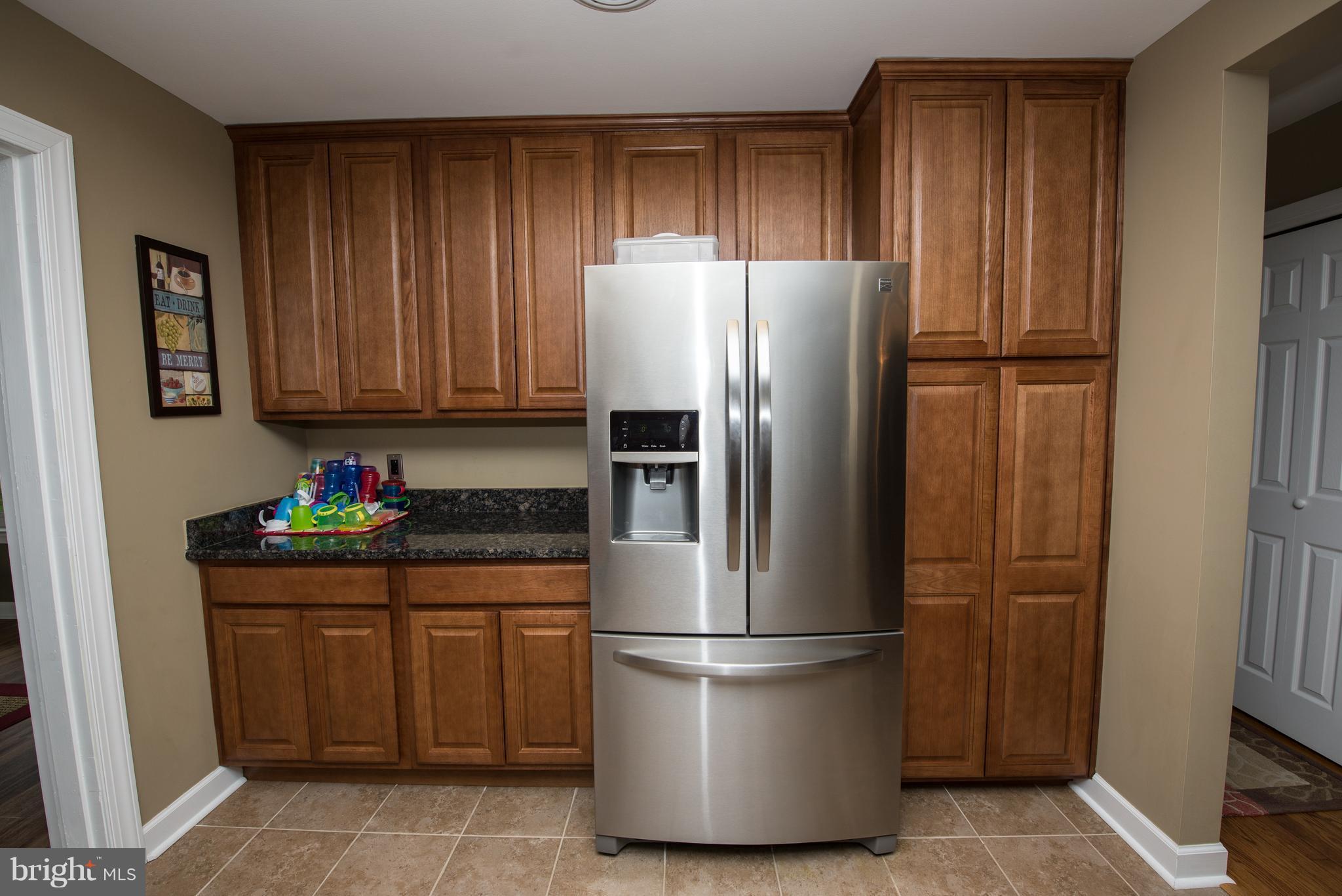 604 Bryan Point Road Accokeek, MD 20607 - Photo 6 of 29 a kitchen with stainless steel appliances a refrigerator and a stove top oven