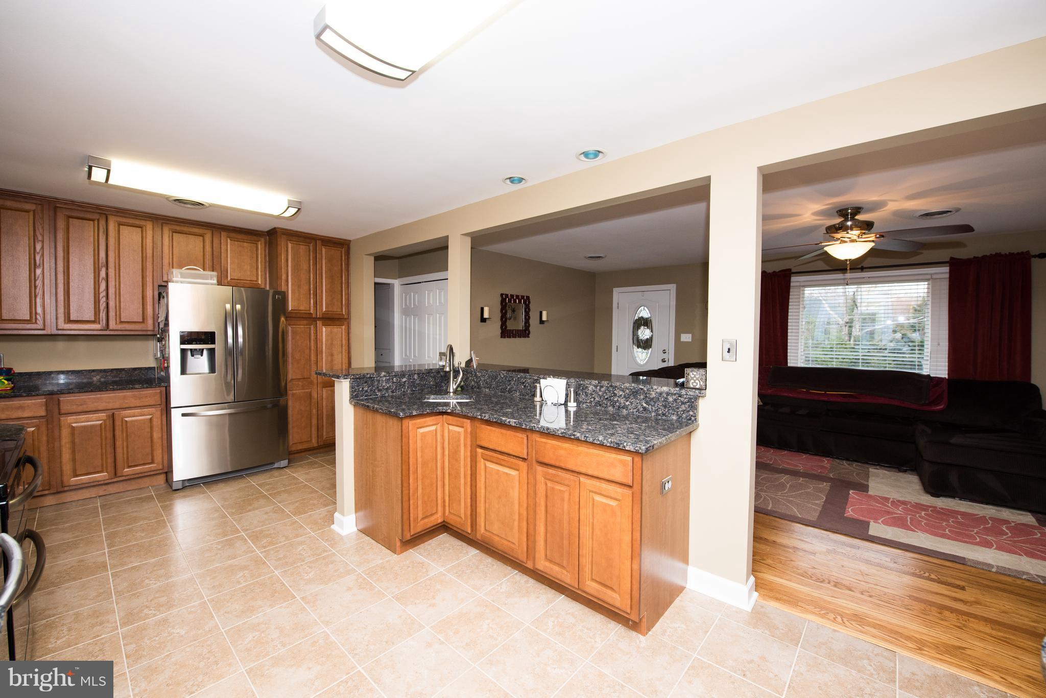604 Bryan Point Road Accokeek, MD 20607 - Photo 7 of 29 a kitchen with stainless steel appliances granite countertop a refrigerator a stove and a sink with granite countertops
