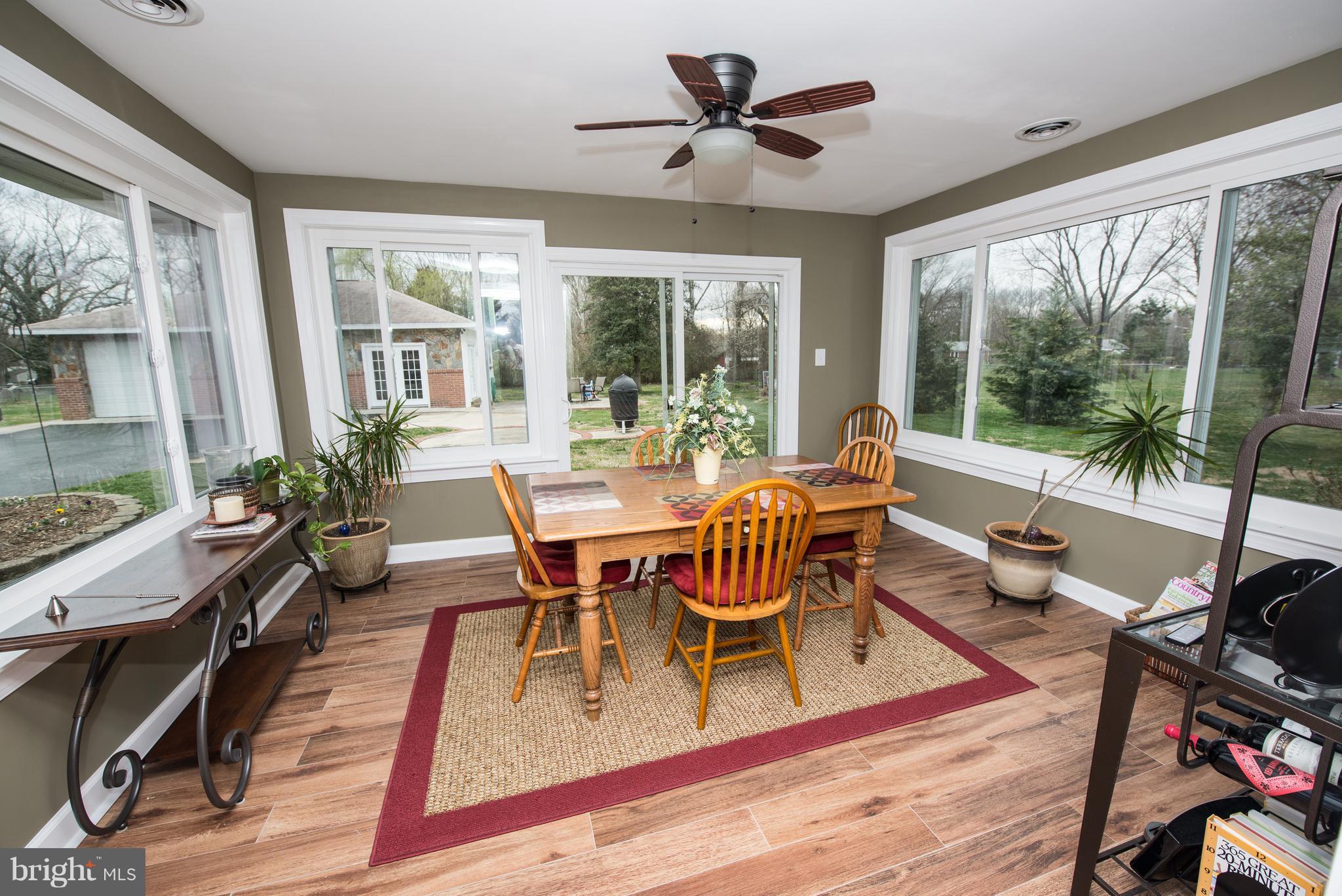 604 Bryan Point Road Accokeek, MD 20607 - Photo 9 of 29 a dining room with wooden floor and a floor to ceiling window