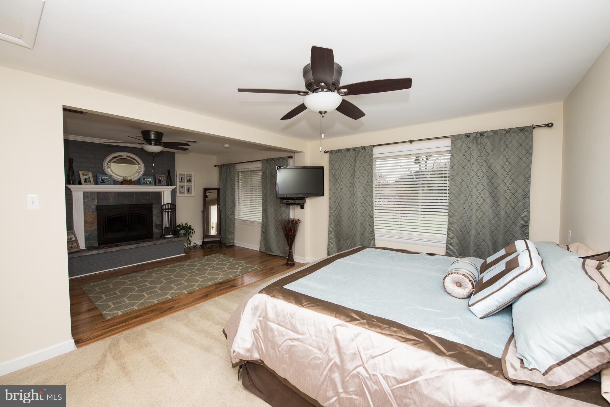 604 Bryan Point Road Accokeek, MD 20607 - Photo 10 of 29 a bedroom with a bed and a fireplace