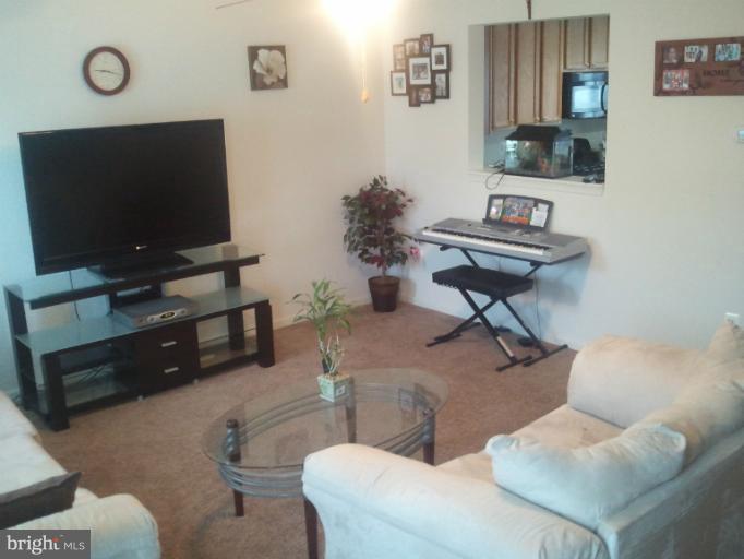 9902 Decatur Road Middle River, MD 21220 - Photo 6 of 18 a living room with furniture and a flat screen tv