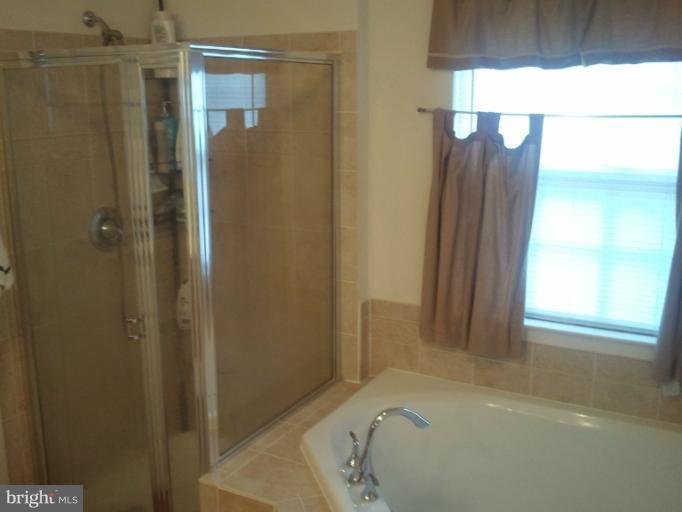 9902 Decatur Road Middle River, MD 21220 - Photo 9 of 18 a bathroom with a bathtub and a shower