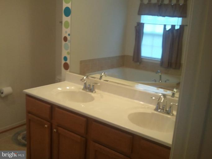 9902 Decatur Road Middle River, MD 21220 - Photo 10 of 18 a bathroom with a sink and a mirror