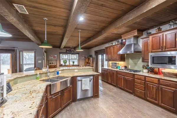 a dining room with furniture a chandelier and wooden floor