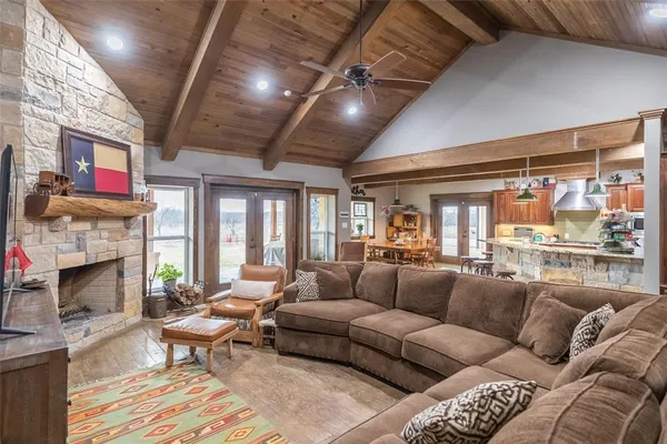 a living room with furniture fireplace and a large window