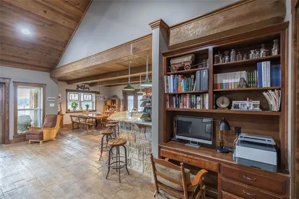 a living room with lots of furniture and a book shelf
