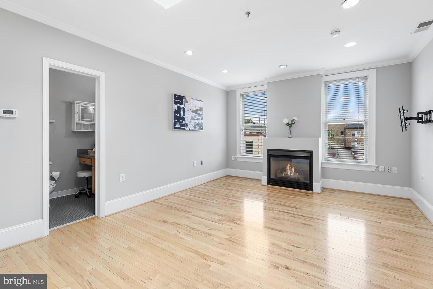 20 Logan Circle Northwest, Unit 32 Washington, DC 20005 - Photo 11 of 23 a view of empty room with wooden floor and fireplace