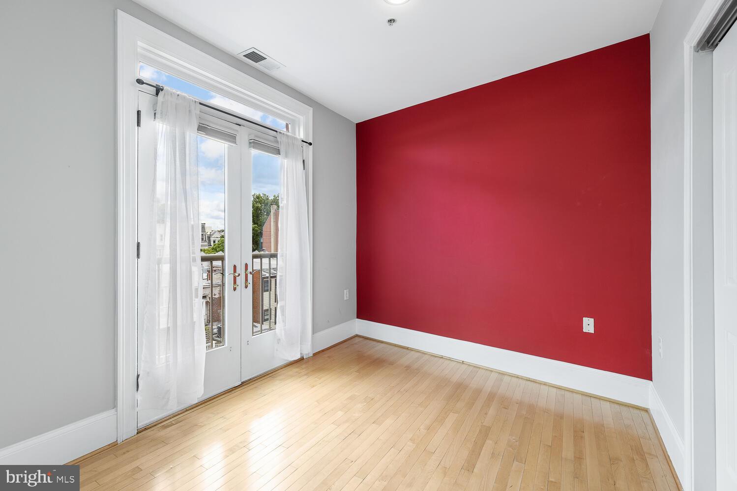20 Logan Circle Northwest, Unit 32 Washington, DC 20005 - Photo 14 of 23 an empty room with wooden floor and windows