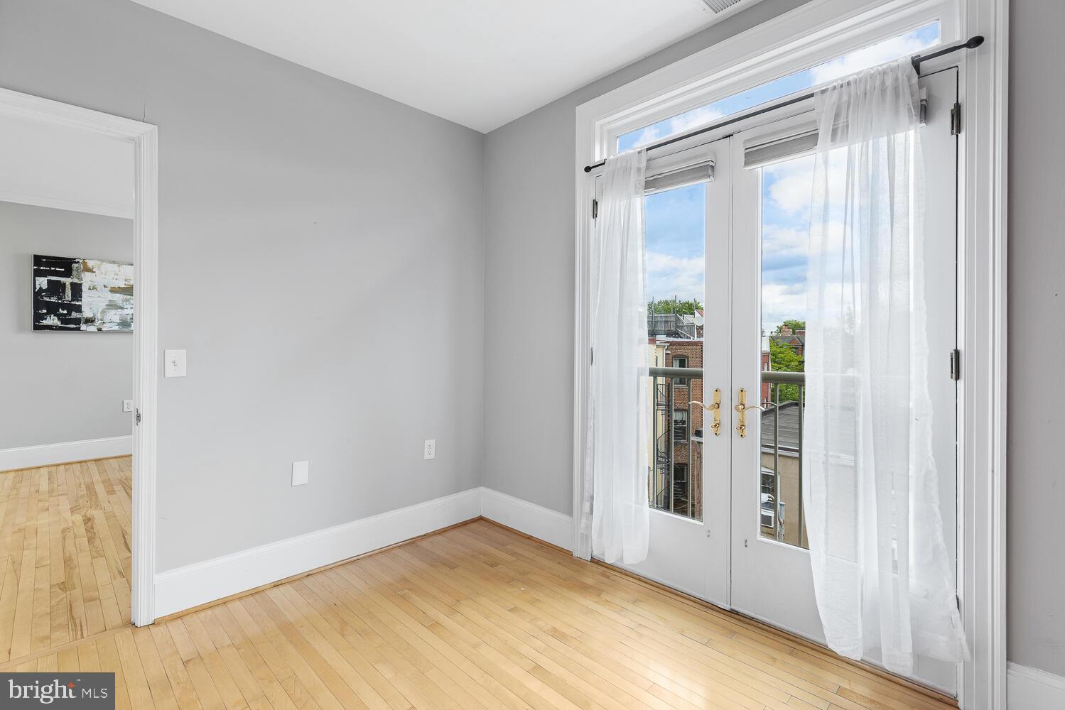 20 Logan Circle Northwest, Unit 32 Washington, DC 20005 - Photo 16 of 23 a view of empty room with wooden floor and fan