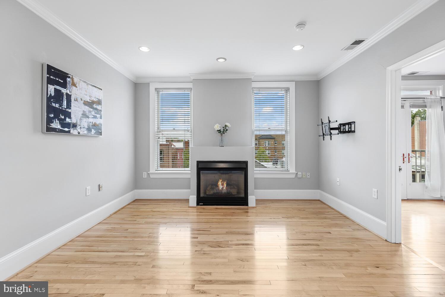 20 Logan Circle Northwest, Unit 32 Washington, DC 20005 - Photo 2 of 23 a view of a livingroom with wooden floor a fireplace and windows
