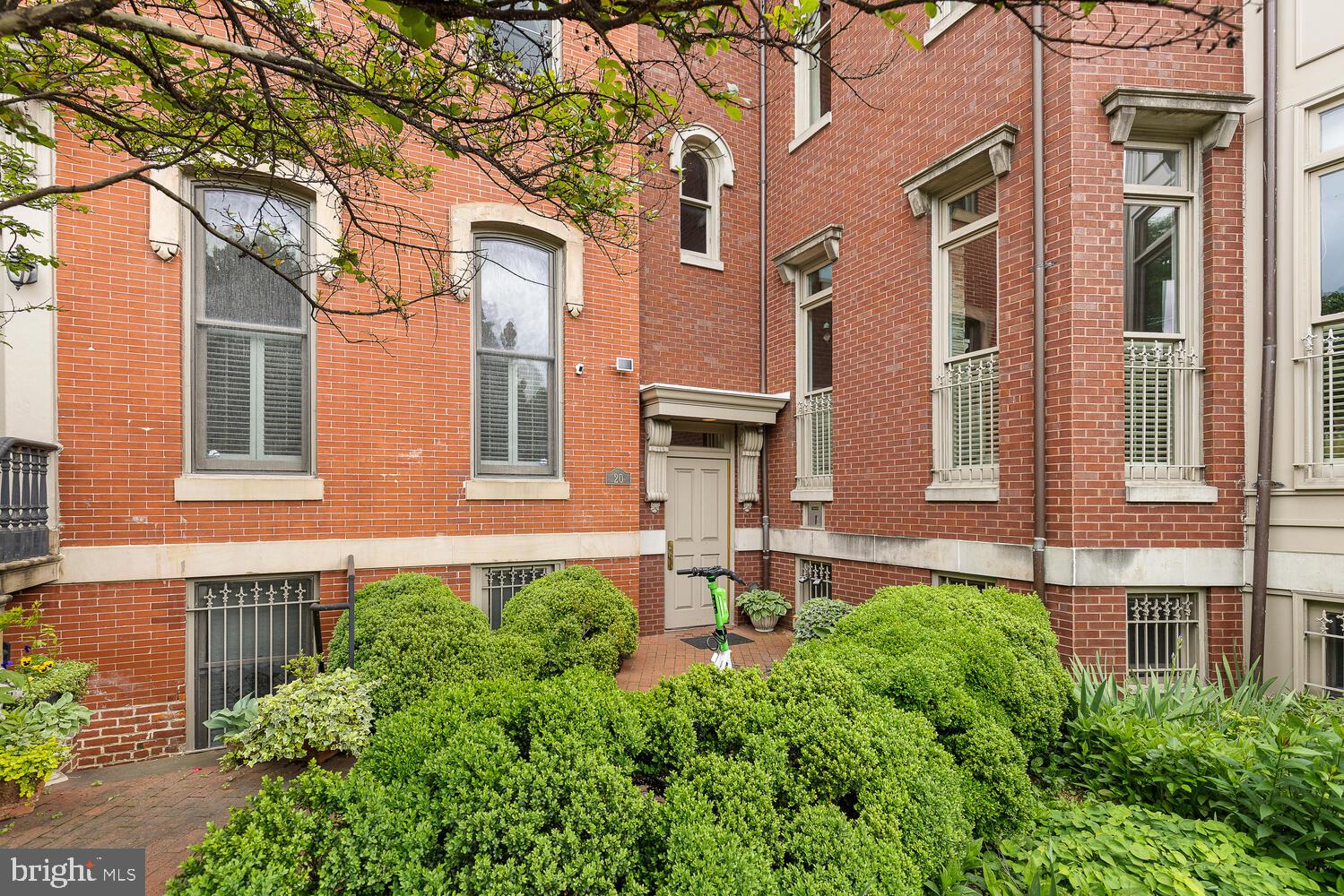 20 Logan Circle Northwest, Unit 32 Washington, DC 20005 - Photo 21 of 23 front view of a brick house with a large windows and a yard